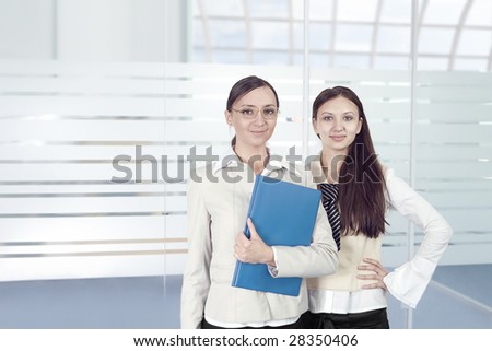 two representative businesswomen in office environment
