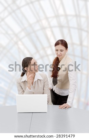 two representative businesswomen in office environment