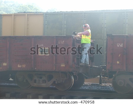 worker standing on rail-car