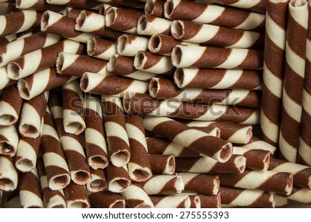 Striped wafer rolls filled with chocolate texture background