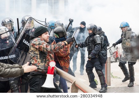 Milan, december 12, 2014 - Police in full riot gear clash with protesting students at the end of the march in solidarity with the general strike called by Unions in Rome and Turin.