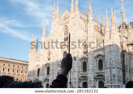 Milan, January 10, 2015 - A pencil, the symbol of freedom of expression after the terroristic attack on the magazine Charlie Hebdo, raised towards the sky, with the Milan Cathedral in the background