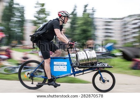 Milan, may 31, 2015 - Urban messenger competes with a cargo bike in the European Cycle Messenger Championship, disputed on an urban circuit of Milan.