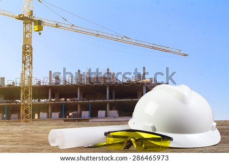 file of safety helmet and architect plant on wood table with  co