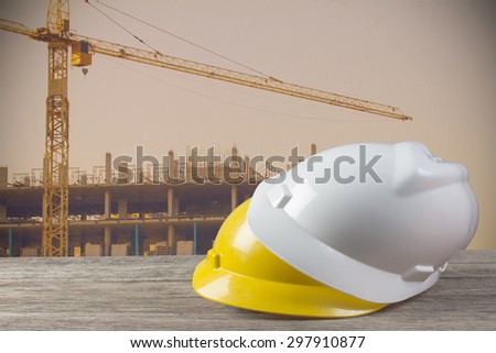 file of safety helmet and architect plant on wood table with  construction,vintage color