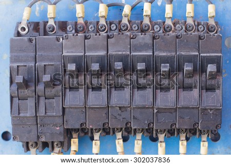 A row of switched electrical circuit breakers