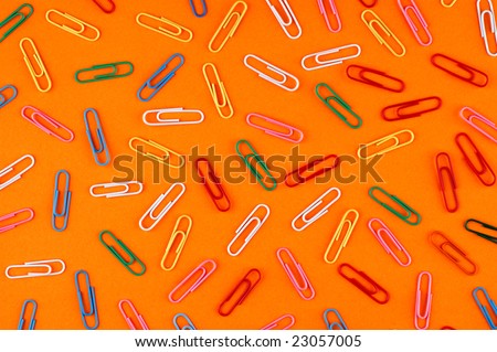 paper clips on orange paper sheet background