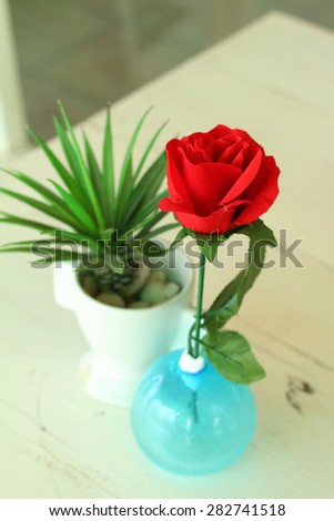 Vase of red flowers on a table