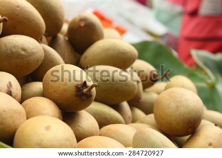 Sapodilla fruit pile in the background