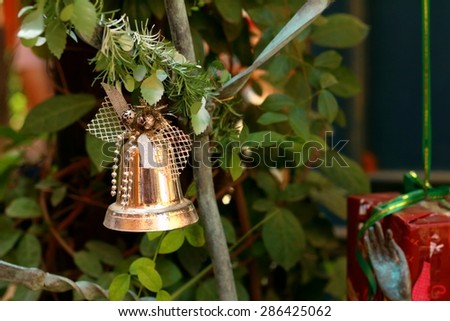 A silver bell on the Christmas tree.