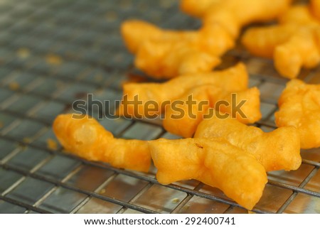 Deep-fried dough stick on a tray  in the market