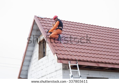 builder performs installation gable roof tiles of metal