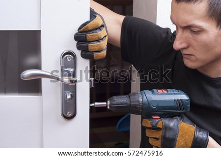 handyman repair the door lock in the room