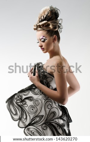 young woman with art make, coiffure, gauzy dress