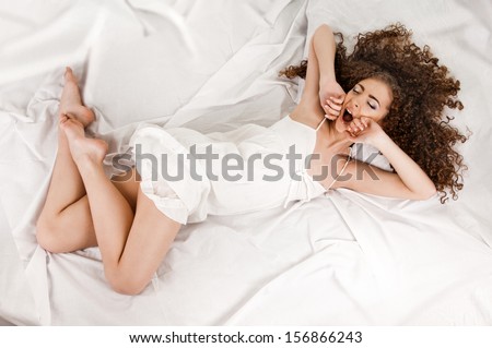 young woman on bed, photo from above