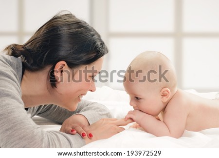 mother with her baby in the room with window background