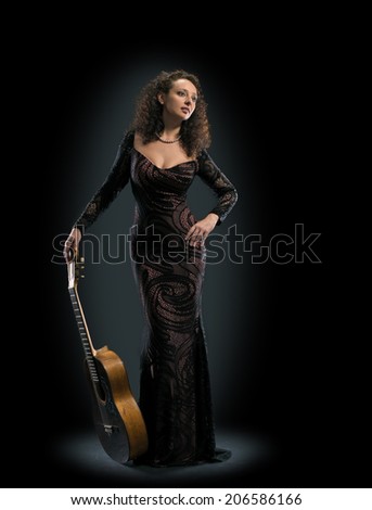 beauty woman player with classical guitar full length on black