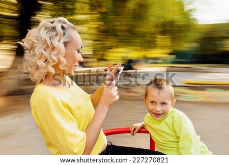 Family having fun on spinning roundabout. selfie Portrait. Naturally blur motion