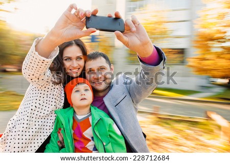 Family having fun on spinning roundabout. selfie Portrait. Naturally blur motion