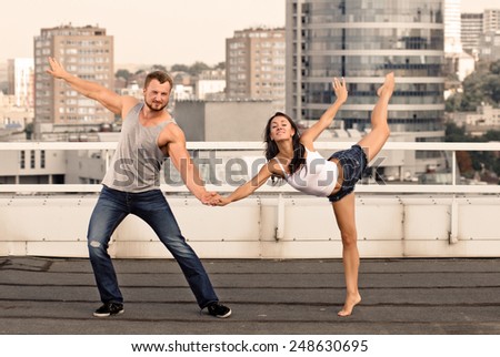 Man and woman in passionate dance pose on the house-top