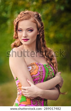 Portrait of a beautiful red-haired young woman summer outdoors. fashion  stroll