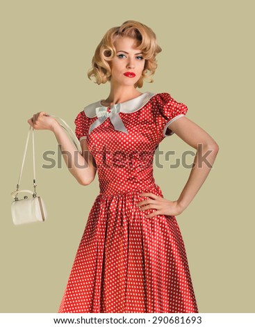 young beautiful caucasian woman posing with purse, over dirty yellow background, retro styling, pin up