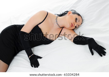 luxurious sleeping  brunette on white bed clothes
