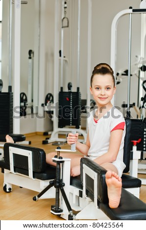 portrait of young beauty gymnast in gymnasium