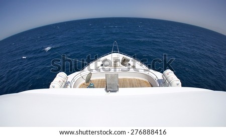 Fish eye shot of boat bow against ocean with curved horizon