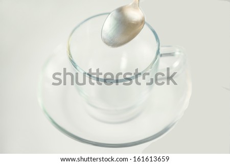 Empty tea cup with tea spoon