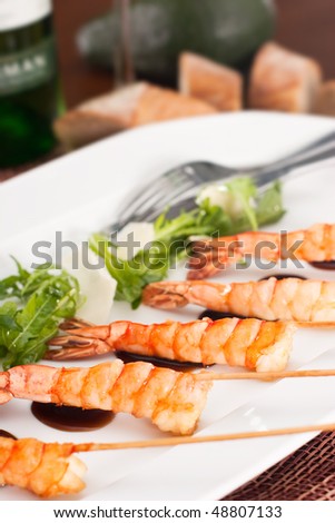 delicatessen dish with prawns on skewer