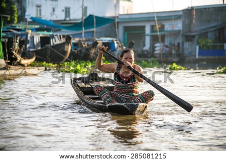 CAN THO, VIETNAM, NOVEMBER 10, 2013: Unidentified woman at floating market in Mekong river delta on November 10, 2013 in Can Tho, Vietnam. Is one of the biggest floating markets on Mekong Delta.