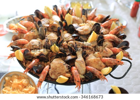 Closeup of paella with seafood and chicken on a table, selective focus