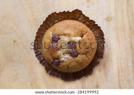 Chocolate chip muffin, slightly unwrapped or opened