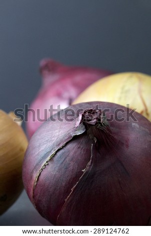 Red and white onions on a dark background