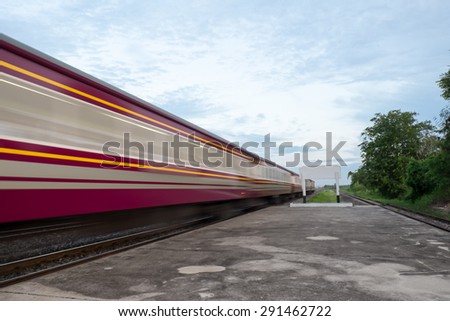High-speed train that runs through rail track and the countryside of Thailand with motion blur, blank board.