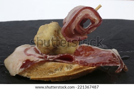 Artichoke Toast with ham and bacon on slate plate