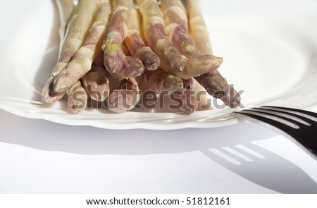Fresh white  Asparagus on white plate with spoon