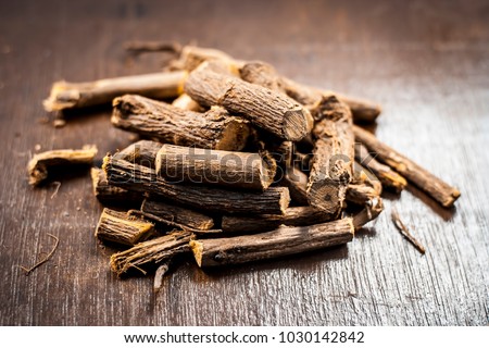 Close up of Ayurvedic herb Liquorice root,Licorice root, Mulethi or Glycyrrhiza glabra root on a wooden surface is very much beneficial for Soothes your stomach,poisoning, stomach ulcers, etc.