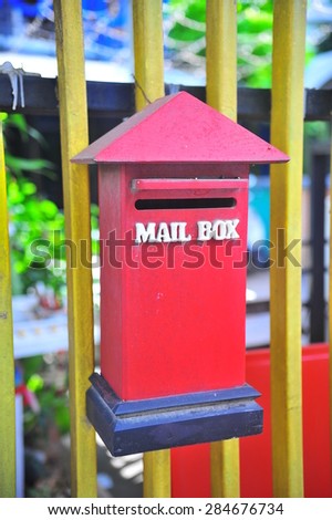 Mail Box In front of a House.