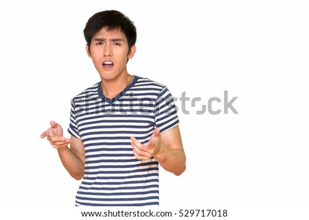 Studio shot of angry Asian man isolated against white background