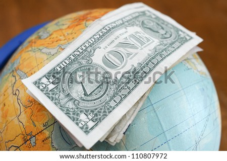 Pile of dollar notes on the globe