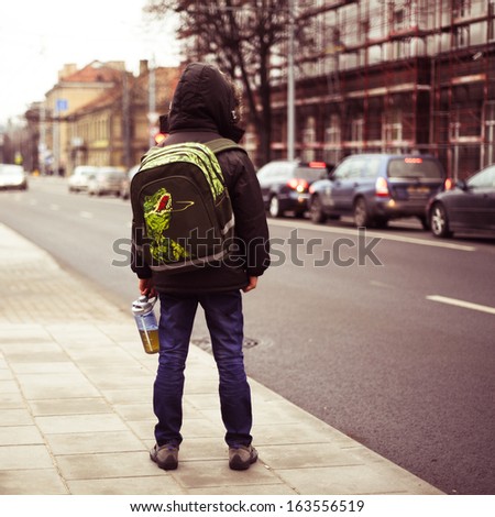 schoolboy alone in the street