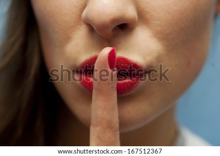 Young sexy woman with finger on her lips