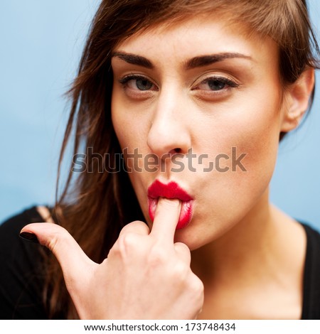 Young nice woman sucking her middle finger