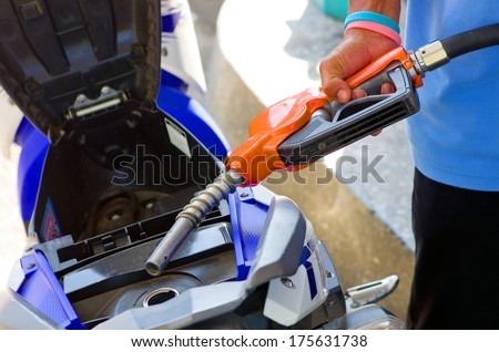 filling gas into the scooter