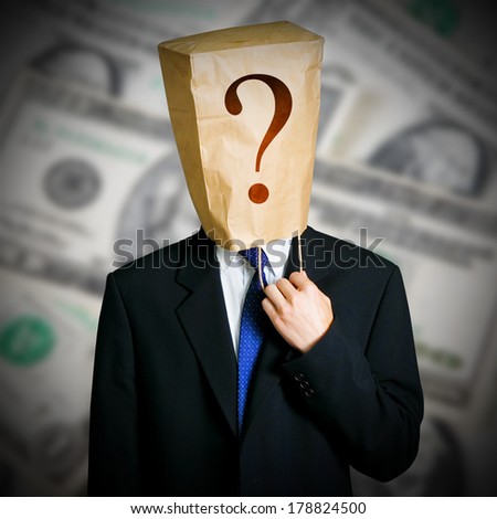 Businessman with a paper bag on head and dollars notes background