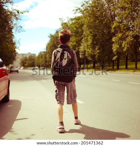 schoolboy walk alone in the street