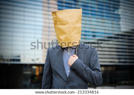 Businessman with paper bag on the head
