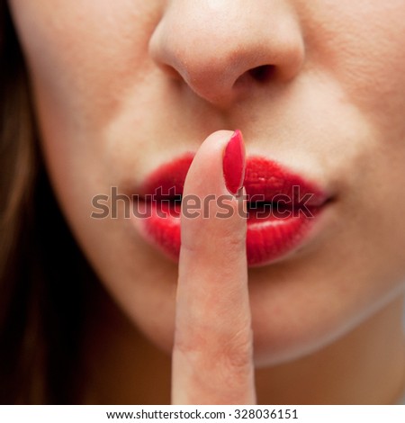 Young sexy woman with finger on her lips